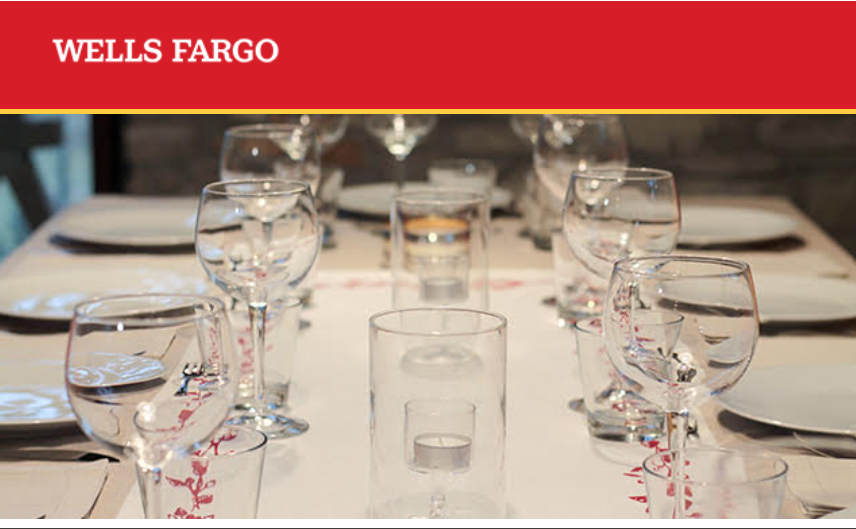 table laid out with glasses and plates for a luncheon