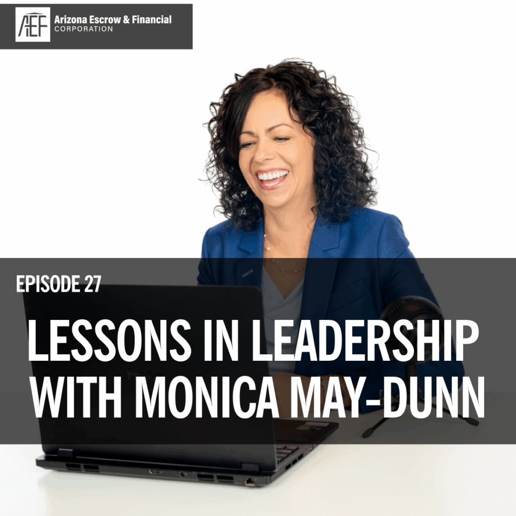 Monica May-Dunn in a blue blazer sits in front of a laptop with the words lessons in leadership written across the image