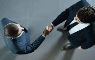 Two men in suits shaking hands